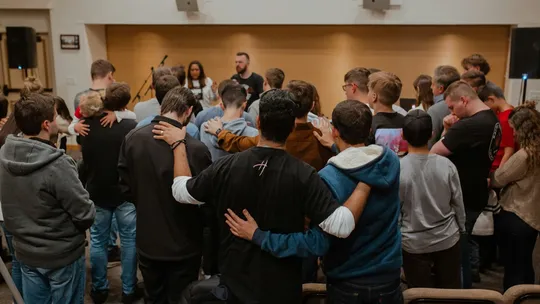 Young adult at youth worship night
